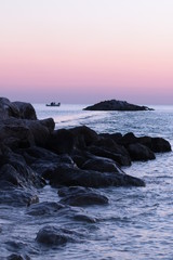 rock barrier in the ocean at dusk