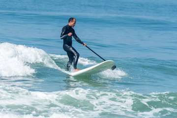 Fototapeta na wymiar Stand up paddle surfer