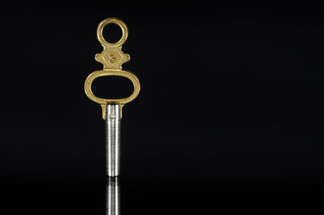 Antique Brass Pocket Watch Key Standing in the Darkness