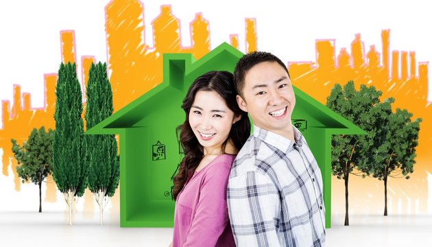 Composite image of smiling asian couple looking at camera