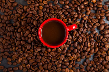 red cup of espresso, coffee with coffee beans around