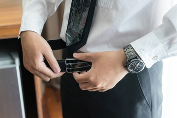 Obraz na płótnie Canvas Man buttons belt to preparation for wedding ceremony or for business work