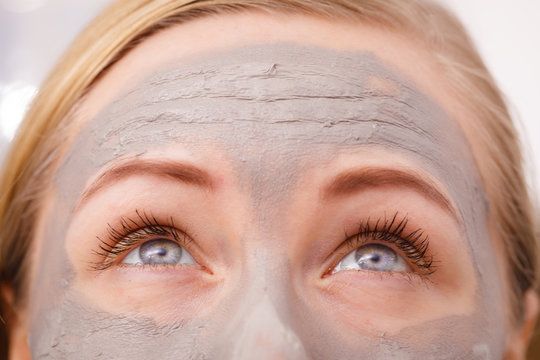 Closeup Of Woman Having Grey Mud Mask On Face