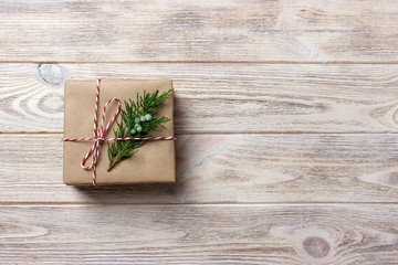 Gift box with red ribbon over white wooden background