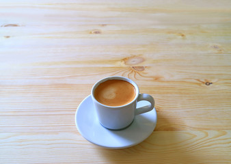 Cup of Hot Coffee Served on a Wooden Table in the Morning Light, with Free Space for Text and Design 