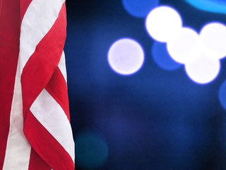 Patriotic Hanging American Flag and Blue Bokeh Lights Background