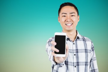 Composite image of portrait of happy man showing smart phone 