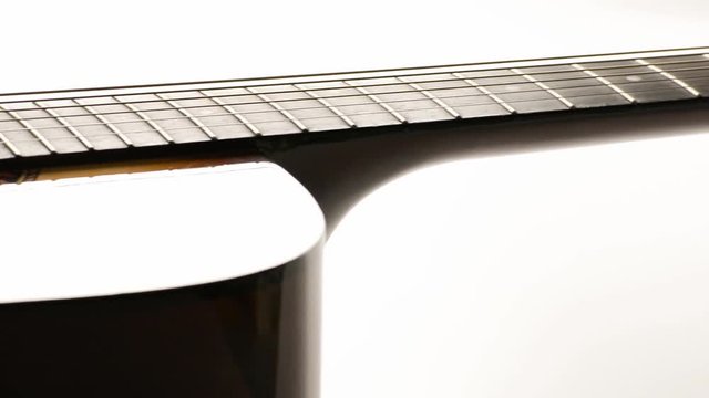 Close up view acoustic guitar dolly motion