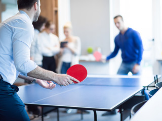 startup business team playing ping pong tennis