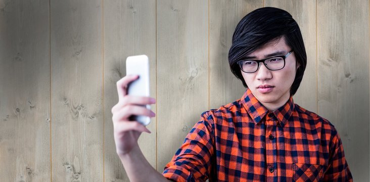 Composite image of cinfident hipster taking a selfie
