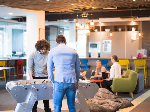 Office People Enjoying Table Soccer Game