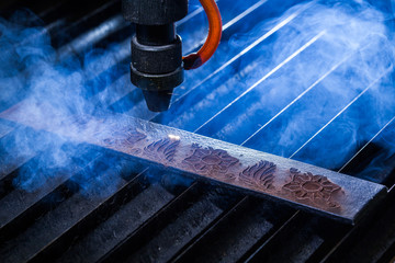 Laser makes engraving on leather belt 