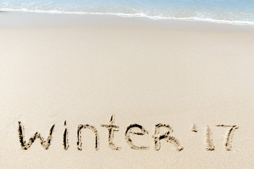 Winter 2017 sign on a sand near sea ocean tropic beach