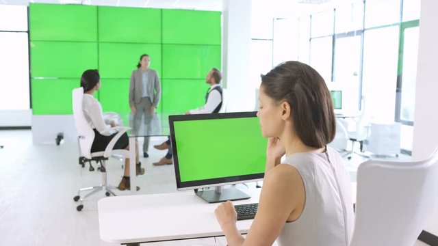  Business team in a meeting in modern office with green screen