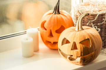 Halloween pumpkin with candle on window. Symbol of halloween.