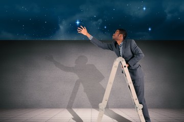 Composite image of businessman climbing up ladder