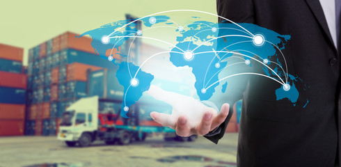 Global network coverage world map on hand of businessman ,Industrial Container Cargo freight ship at habor for Logistic Import Export background (Elements of this image furnished by NASA)
