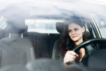 Young beautiful girl driving a car