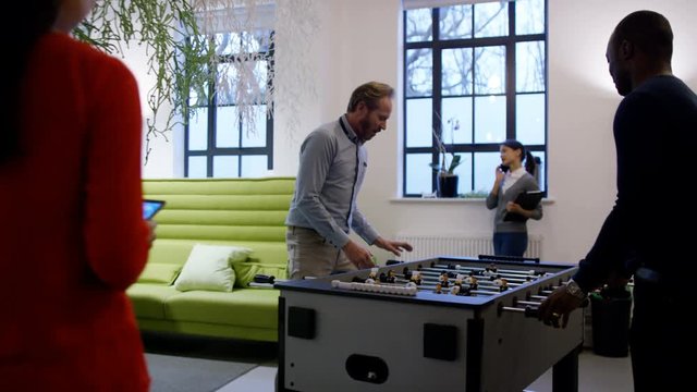  Business Team In Creative Office Working & Playing Fussball In Breakout Area