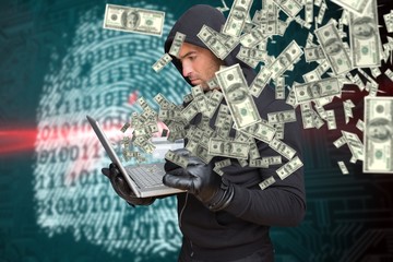 Composite image of hacker holding laptop and credir card