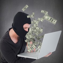 Composite image of hacker using laptop to steal identity