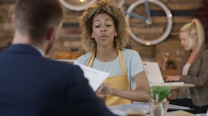 Cafe owner in a meeting with banker, getting a loan for the business