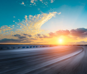 Motion blur asphalt road circuit and beautiful sky clouds at sunset
