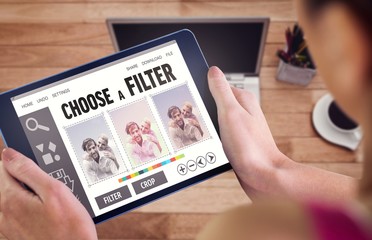 Composite image of woman using tablet pc