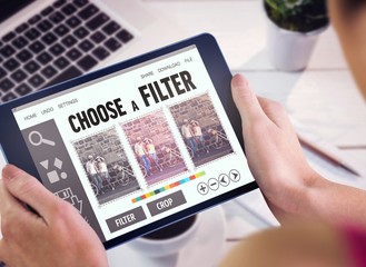 Composite image of woman using tablet pc