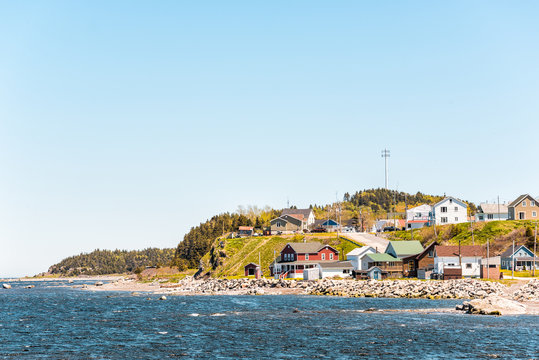 Cityscape of Grosses-Roches village town and Saint-Lawrence river during day with colorful houses