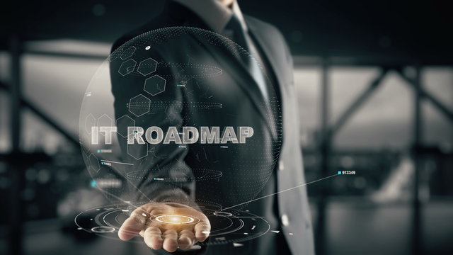 IT Roadmap With Hologram Businessman Concept