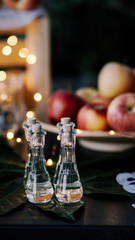 A few glasses of alcohol on the decorated table, apple in background