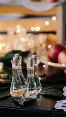 A few glasses of alcohol on the decorated table, illuminated background