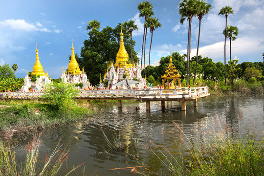 Buddhist pagoda on the lake with a golden stupas with gilded roof near the monastery of Inwa  in the Mandaly region of Myanmar,Burma
