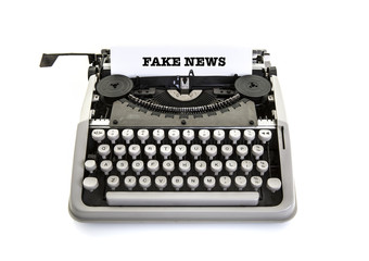Fake News on an old vintage typewriter on a white background