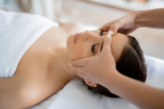 Calm Girl Having Spa Facial Massage In Luxurious Beauty Salon