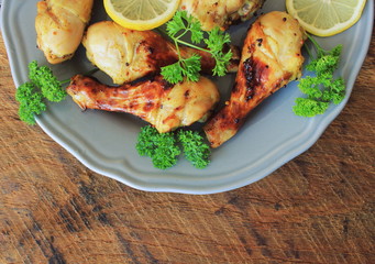 Grilled chicken legs with mustard on cutting board.Rustic dinner background . Top view