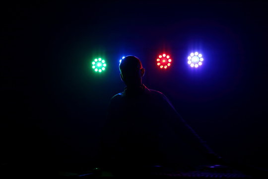 DJ in the light of the floodlights.
