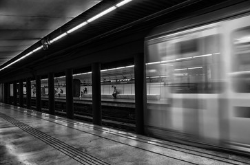 Fototapeta na wymiar Moving train leaving platform on underground station, Barcelona, Spain