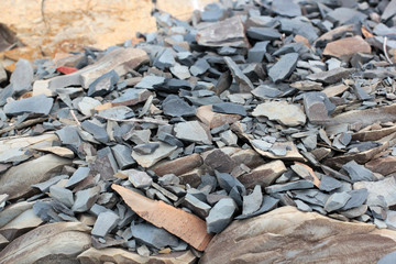 Cracks and colorful layers of sandstone background. A big heap of sandstones, storage space of various natural sandstone. The pattern of the variegated sandstones. Layers of toning colored stones