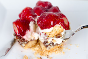 Strawberry on Fork with Pie Behind