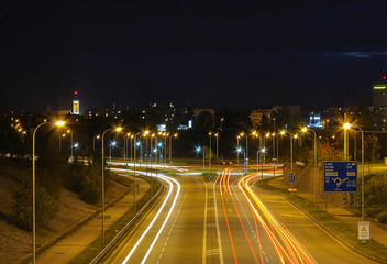 Fototapeta na wymiar Street and car at night on long exposure with Ceske Budejovice in background