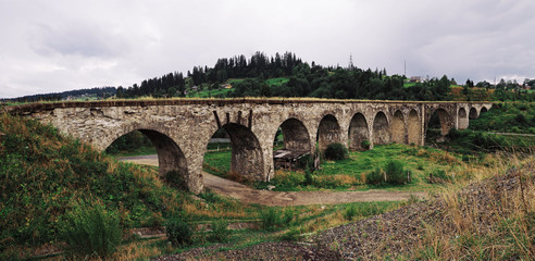 Panorama of the old austrian bridge through the river at the Karpatian mountains view from beginning