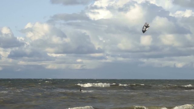 Kiteboarding, Fun in the ocean, Extreme Sport. Extreme Kitesurfing in stormy weather. Summer Ocean Sport in Slow Motion.