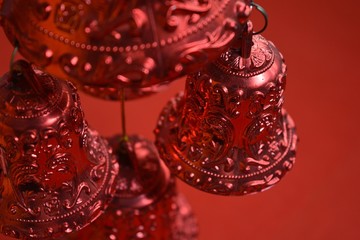 Christmas bells decoration on red background.