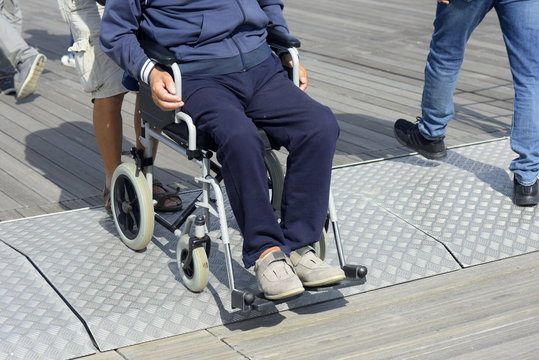 Man using wheelchair on street