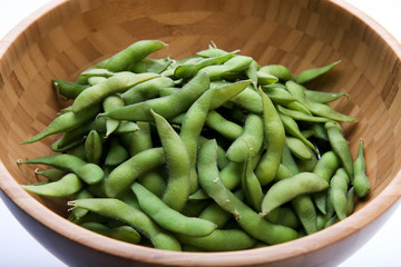 Fresh green peas in the  wood bowl
