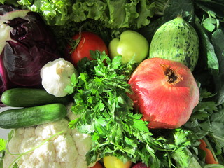 pomegranate,garlic,lettuce,cantaloupe,maydonos,cucumber,tomato,lemon,spinach,carrots,broccoli,collard greens.vegetables ,fruits,background 