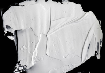 White wet paint or cream isolated on black background for ideas