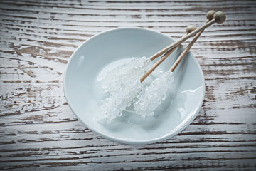 Sugar sticks plate on vintage wooden board